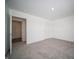 A brightly lit bedroom showcases neutral carpet, white walls, with a doorway leading to an adjacent room at 1407 Foxtail Ln, Greenwood, IN 46143