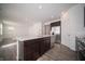 Kitchen island featuring stainless dishwasher, sink, and seating at 1407 Foxtail Ln, Greenwood, IN 46143