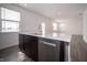 Kitchen island with a stainless dishwasher and sink at 1407 Foxtail Ln, Greenwood, IN 46143