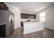 Modern kitchen featuring stainless appliances, a large island, and ample counter space at 1407 Foxtail Ln, Greenwood, IN 46143