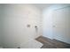 Functional laundry room featuring hookups and overhead shelving for organized storage at 1407 Foxtail Ln, Greenwood, IN 46143
