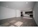 Bright, open-concept living room and kitchen featuring dark cabinetry and gray wood-look floors at 1407 Foxtail Ln, Greenwood, IN 46143
