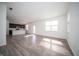 Open-concept living room with laminate flooring, an island bar, white walls and windows, and recessed lighting at 1407 Foxtail Ln, Greenwood, IN 46143