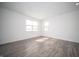 Spacious living room featuring laminate flooring, white walls, large window, and recessed lighting at 1407 Foxtail Ln, Greenwood, IN 46143