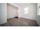 Bright living room with gray laminate flooring, white walls, large window, and plenty of natural light at 1407 Foxtail Ln, Greenwood, IN 46143