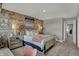 Bright bedroom with exposed brick wall, cozy decor, and open access to the hallway at 15377 Manderley St, Fishers, IN 46040