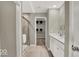 Bright bathroom featuring double sinks, walk-in shower, and access to a walk-in closet at 16923 Sandhurst Pl, Westfield, IN 46074