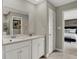 Bright bathroom featuring double sinks, a framed mirror, and direct access to the bedroom at 16923 Sandhurst Pl, Westfield, IN 46074