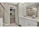 Modern bathroom with a double sink vanity, framed mirror, shower and direct access to walk-in closet at 16923 Sandhurst Pl, Westfield, IN 46074