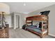Cozy bedroom showcasing a bunk bed, neutral walls, and accent furniture at 16923 Sandhurst Pl, Westfield, IN 46074