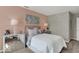 Cozy bedroom featuring natural lighting, a comfortable bed, and soft pink walls at 16923 Sandhurst Pl, Westfield, IN 46074