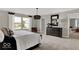 Spacious bedroom featuring an elegant lighting fixture, soft carpet, and large windows at 16923 Sandhurst Pl, Westfield, IN 46074