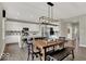 Spacious dining area with a wooden table, chair seating, and an open layout to the kitchen and living room at 16923 Sandhurst Pl, Westfield, IN 46074