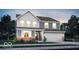 Beautiful two-story home featuring gray siding, brick accents, and a two-car garage at 16923 Sandhurst Pl, Westfield, IN 46074