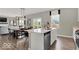Open-concept kitchen and dining area with a large island, stainless steel appliances, and a view of the backyard at 16923 Sandhurst Pl, Westfield, IN 46074