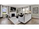 Bright living room with fireplace, large windows, and wood-look flooring at 16923 Sandhurst Pl, Westfield, IN 46074
