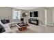 Carpeted living room with mounted television and modern accents at 16923 Sandhurst Pl, Westfield, IN 46074
