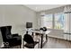 Home office featuring a glass desk, black chairs, two large windows, and grey walls at 16923 Sandhurst Pl, Westfield, IN 46074