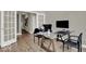 Spacious home office with luxury vinyl flooring, neutral walls, and a glass desk at 16923 Sandhurst Pl, Westfield, IN 46074