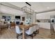 Open floor plan dining area with modern chandelier and view into the living room at 16960 Sandhurst Pl, Westfield, IN 46074