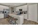 Kitchen island with white cabinets, quartz countertops, stainless steel appliances, and bar stool seating at 16960 Sandhurst Pl, Westfield, IN 46074