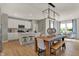 Open-concept kitchen and dining area featuring white cabinets, stainless steel appliances, and ample seating at 16960 Sandhurst Pl, Westfield, IN 46074