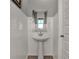 Stylish half-bathroom with a pedestal sink and subway tile walls at 16966 Sandhurst Pl, Westfield, IN 46074