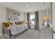 Bright bedroom with gallery wall of animal pictures and gray curtains framing a pleasant outdoor view at 16966 Sandhurst Pl, Westfield, IN 46074