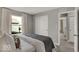 Bright bedroom featuring gray walls, a window view, and sliding closet doors for a seamless design at 16966 Sandhurst Pl, Westfield, IN 46074