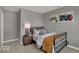 Charming bedroom featuring neutral gray walls, tractor art, and a metal bed frame for a rustic yet modern feel at 16966 Sandhurst Pl, Westfield, IN 46074