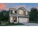 Charming two-story home featuring a covered porch, stone accents, and an attached two-car garage at 16966 Sandhurst Pl, Westfield, IN 46074