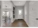 Inviting foyer showcasing hardwood floors, a welcome mat, neutral paint colors, and a view into the home at 16966 Sandhurst Pl, Westfield, IN 46074