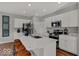 Modern kitchen featuring a large island, stainless steel appliances, and white cabinets at 16966 Sandhurst Pl, Westfield, IN 46074