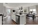 Spacious kitchen island with sink, dishwasher and modern finishes open to the living area at 16966 Sandhurst Pl, Westfield, IN 46074