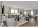 Comfortable living room featuring hardwood floors, bright windows, and a neutral color palette at 16966 Sandhurst Pl, Westfield, IN 46074