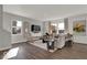 Bright living room features hardwood floors, large windows, and a comfortable seating area with neutral decor at 16966 Sandhurst Pl, Westfield, IN 46074