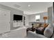 Cozy living room with a comfortable seating area, mounted TV, and neutral color palette at 16966 Sandhurst Pl, Westfield, IN 46074