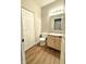 Neutral bathroom featuring a vanity, toilet, mirror, and enclosed shower at 2231 Colfax Ln, Indianapolis, IN 46260