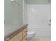Bright bathroom features a white tile shower-tub combo, neutral walls, and granite countertop at 2231 Colfax Ln, Indianapolis, IN 46260