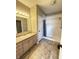 Bathroom with single sink vanity and step-in shower with curtain at 2231 Colfax Ln, Indianapolis, IN 46260