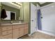 Bright bathroom features a vanity with a stone countertop and a shower-tub combo at 2231 Colfax Ln, Indianapolis, IN 46260