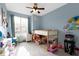 Cheerful bedroom features a loft bed with playful decor and a window for natural light at 2231 Colfax Ln, Indianapolis, IN 46260