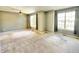 Bedroom with fan, two large windows, and neutral carpeting at 2231 Colfax Ln, Indianapolis, IN 46260