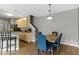 Open dining area with wooden table, modern light fixture and hardwood floors at 2231 Colfax Ln, Indianapolis, IN 46260