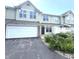 Two-story home with a garage and manicured landscaping gives this house curb appeal at 2231 Colfax Ln, Indianapolis, IN 46260