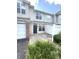 Charming townhouse exterior features a front entry, attached garage, and a well-manicured lawn at 2231 Colfax Ln, Indianapolis, IN 46260