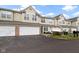 Charming two-story townhome boasts an attached garage, a private patio, and manicured landscaping at 2231 Colfax Ln, Indianapolis, IN 46260