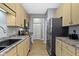 Well-lit kitchen offers ample cabinet space, sleek appliances, and neutral countertops at 2231 Colfax Ln, Indianapolis, IN 46260