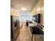Functional kitchen with black appliances, light-colored cabinets, and hardwood-style flooring at 2231 Colfax Ln, Indianapolis, IN 46260