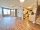 A cozy living area transitions to the kitchen, with hardwood floors, fan, and stairs at 2231 Colfax Ln, Indianapolis, IN 46260